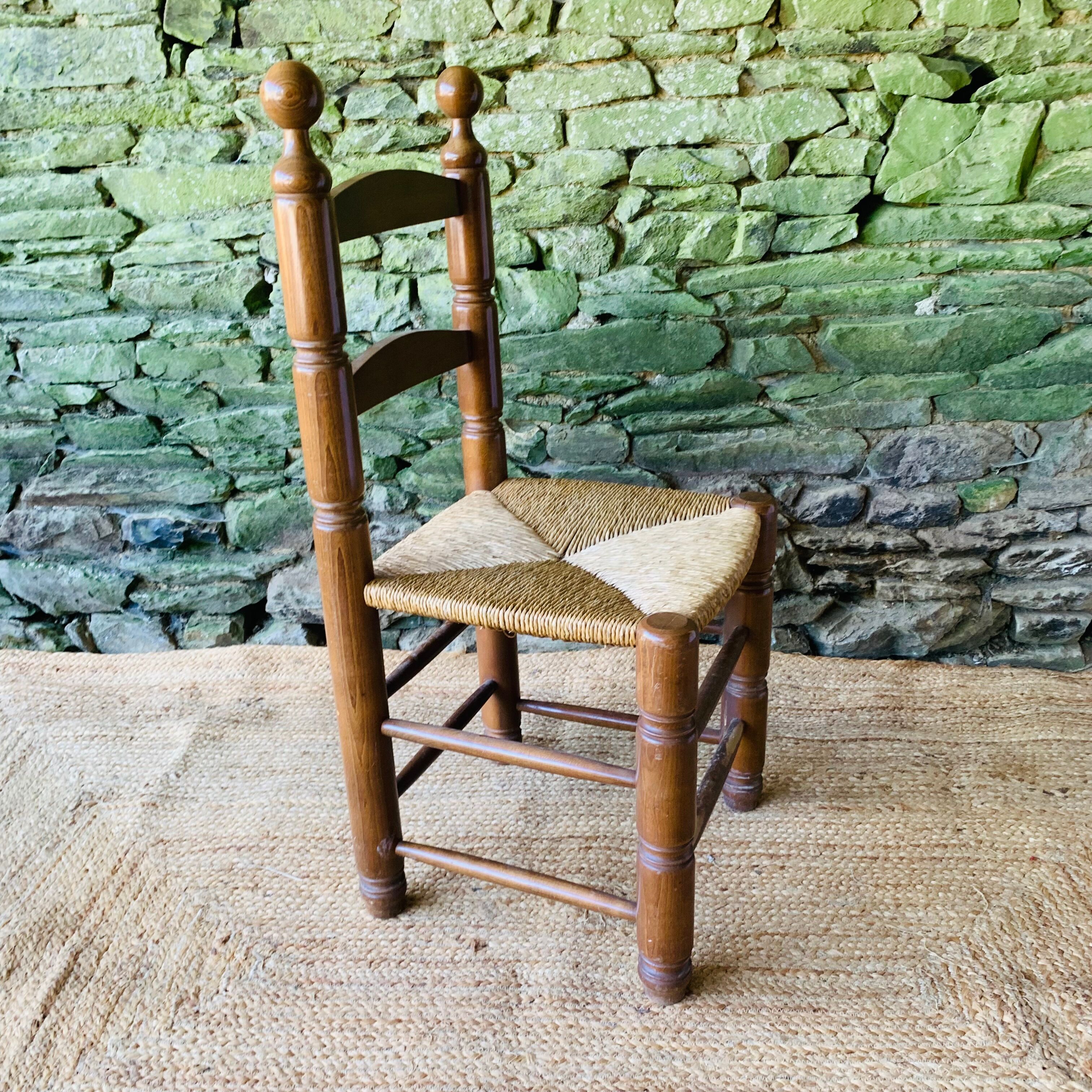 Set of 4 solid wood chairs with straw seats.