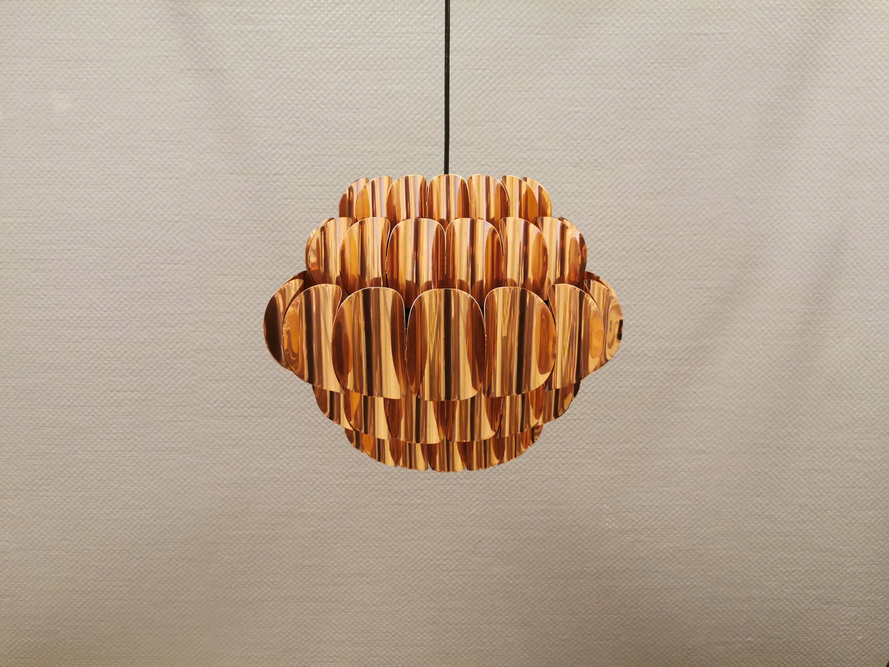 Copper colored hanging lamp. designed by thorsten orrling sweden