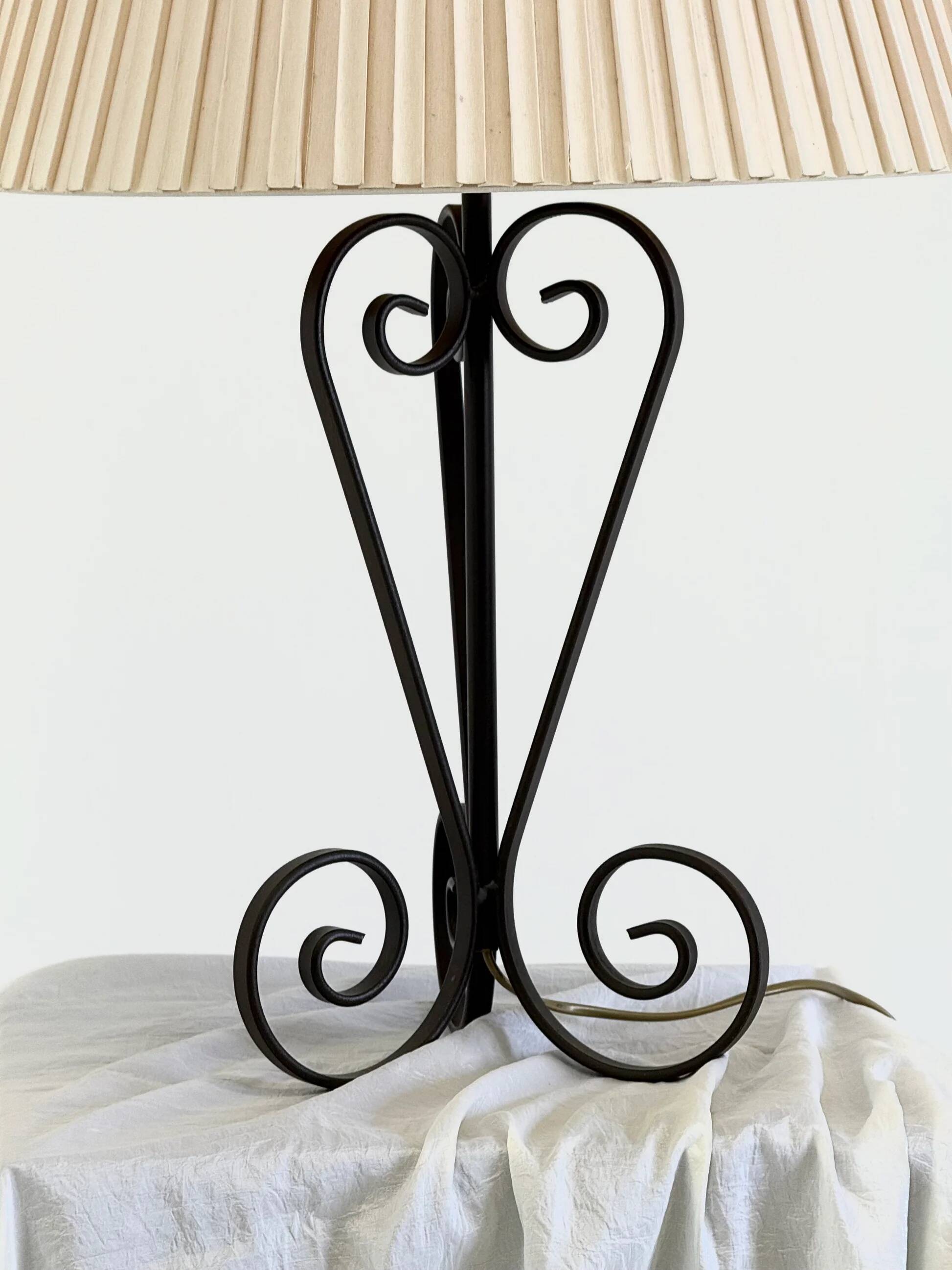 Vintage wrought iron table lamp in swirl shape with pleated shade