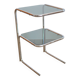 Glass-topped side table with tubular metal.