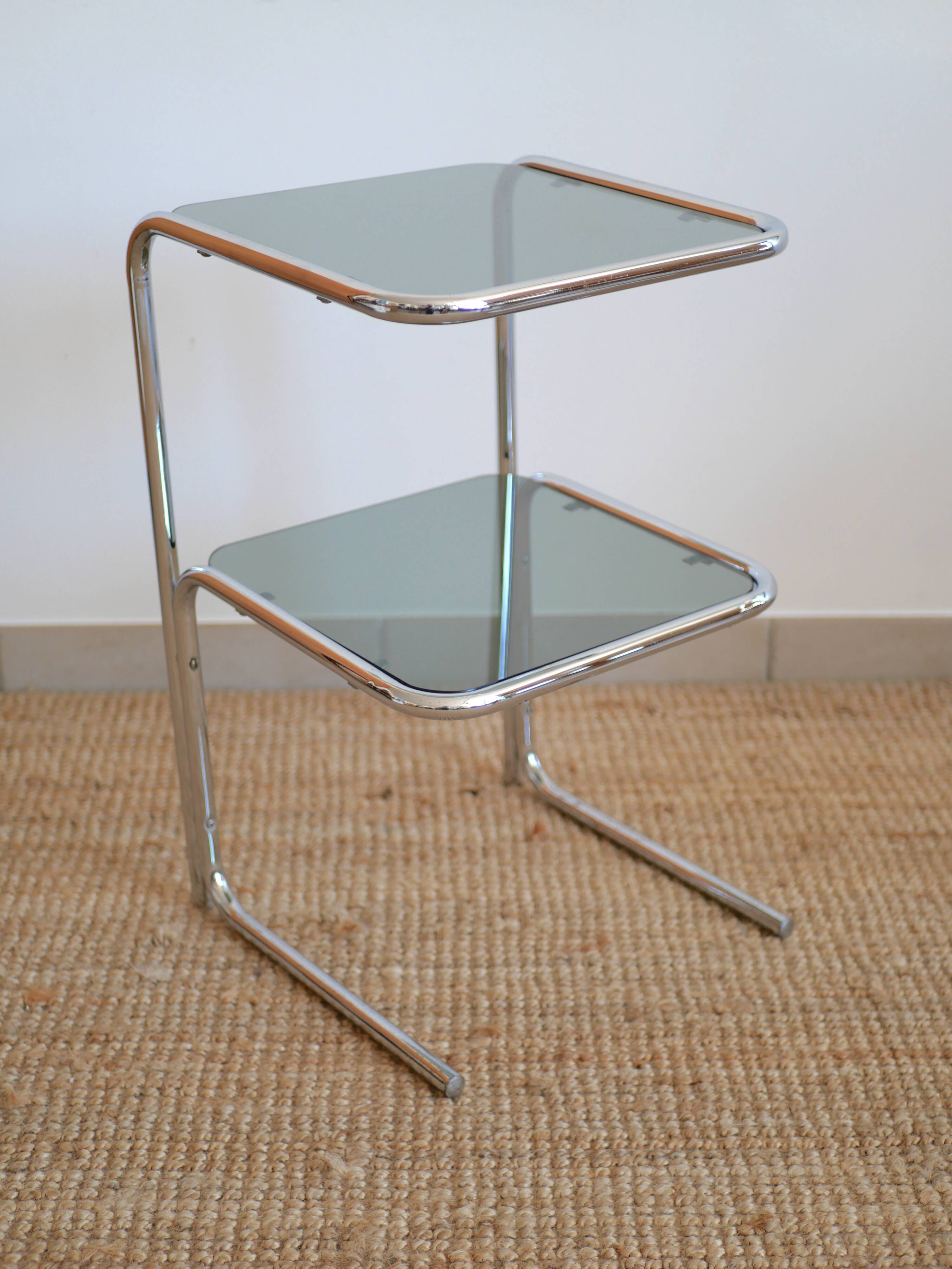 Glass-topped side table with tubular metal.