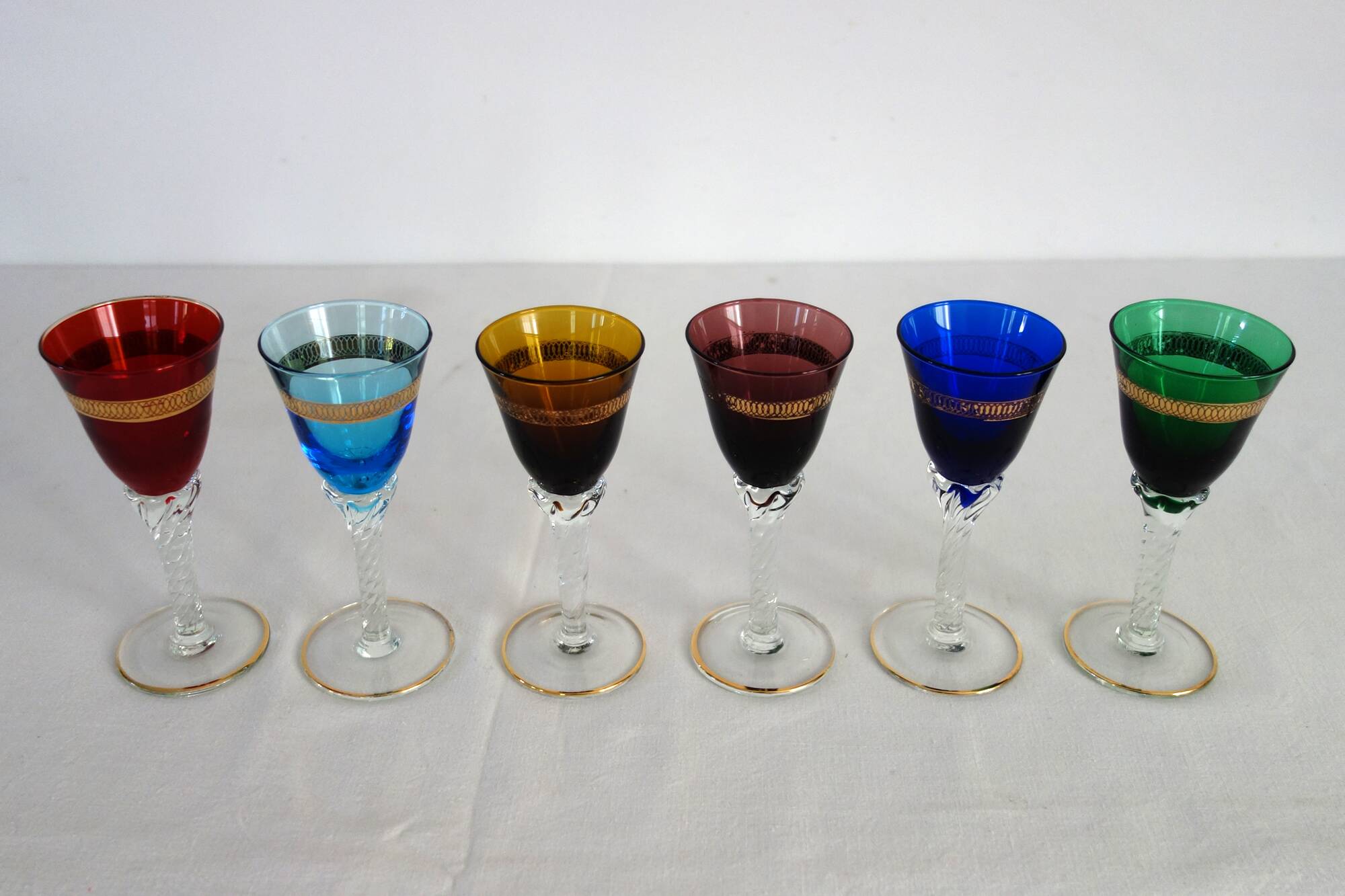 6 multicolored aperitif glasses with twisted legs
