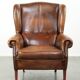 Wingback armchair made of sheepskin leather finished with decorative nails