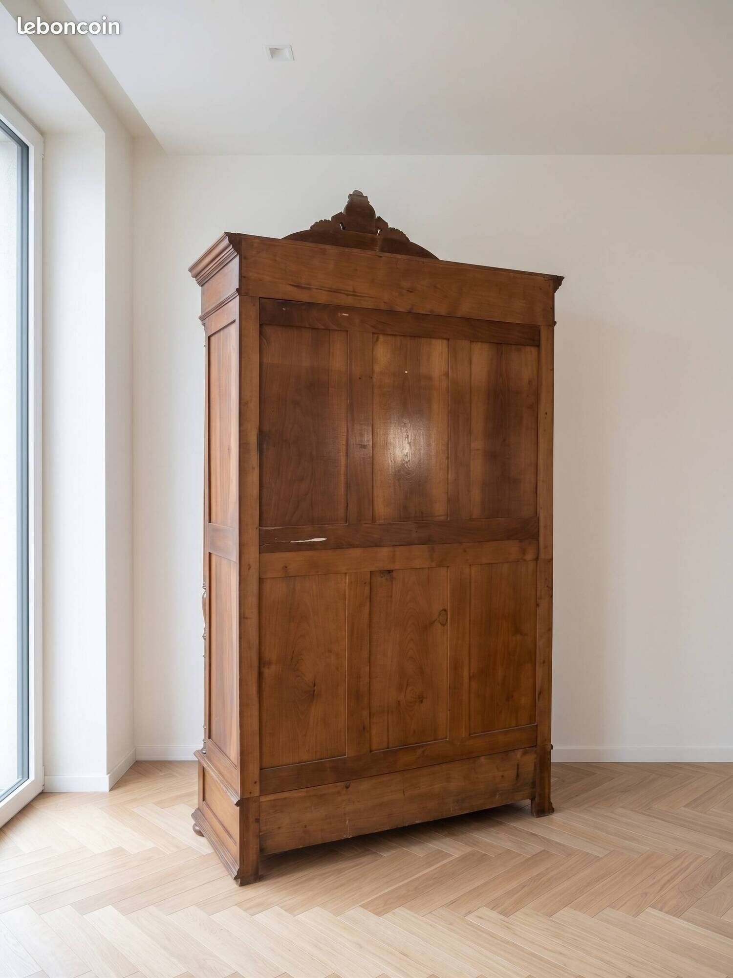Antique walnut wardrobe with bevelled mirrors.