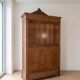 Antique walnut wardrobe with bevelled mirrors.