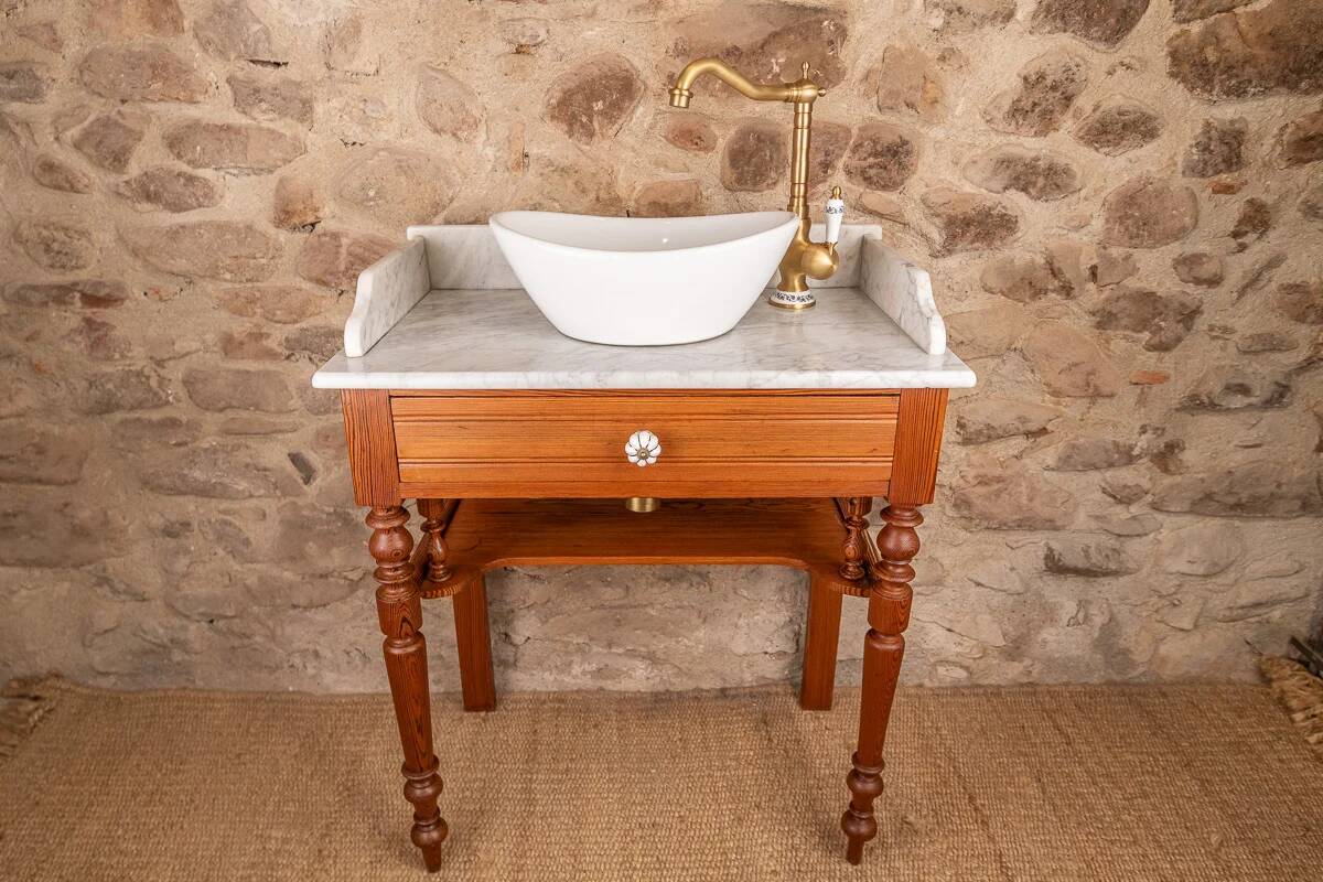 Antique washbasin cabinet in solid pitch pine with a white marble top.