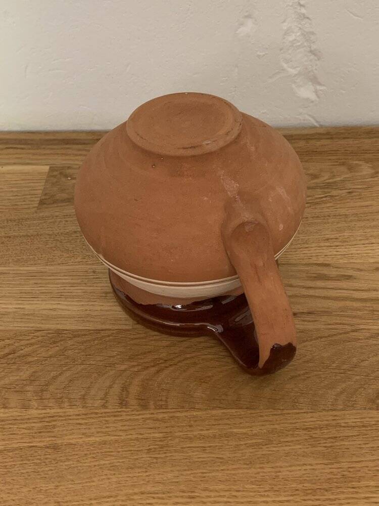 Hungarian folk ceramic pitcher in glossy brown and beige, traditional rounded pot.