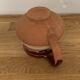 Hungarian folk ceramic pitcher in glossy brown and beige, traditional rounded pot.