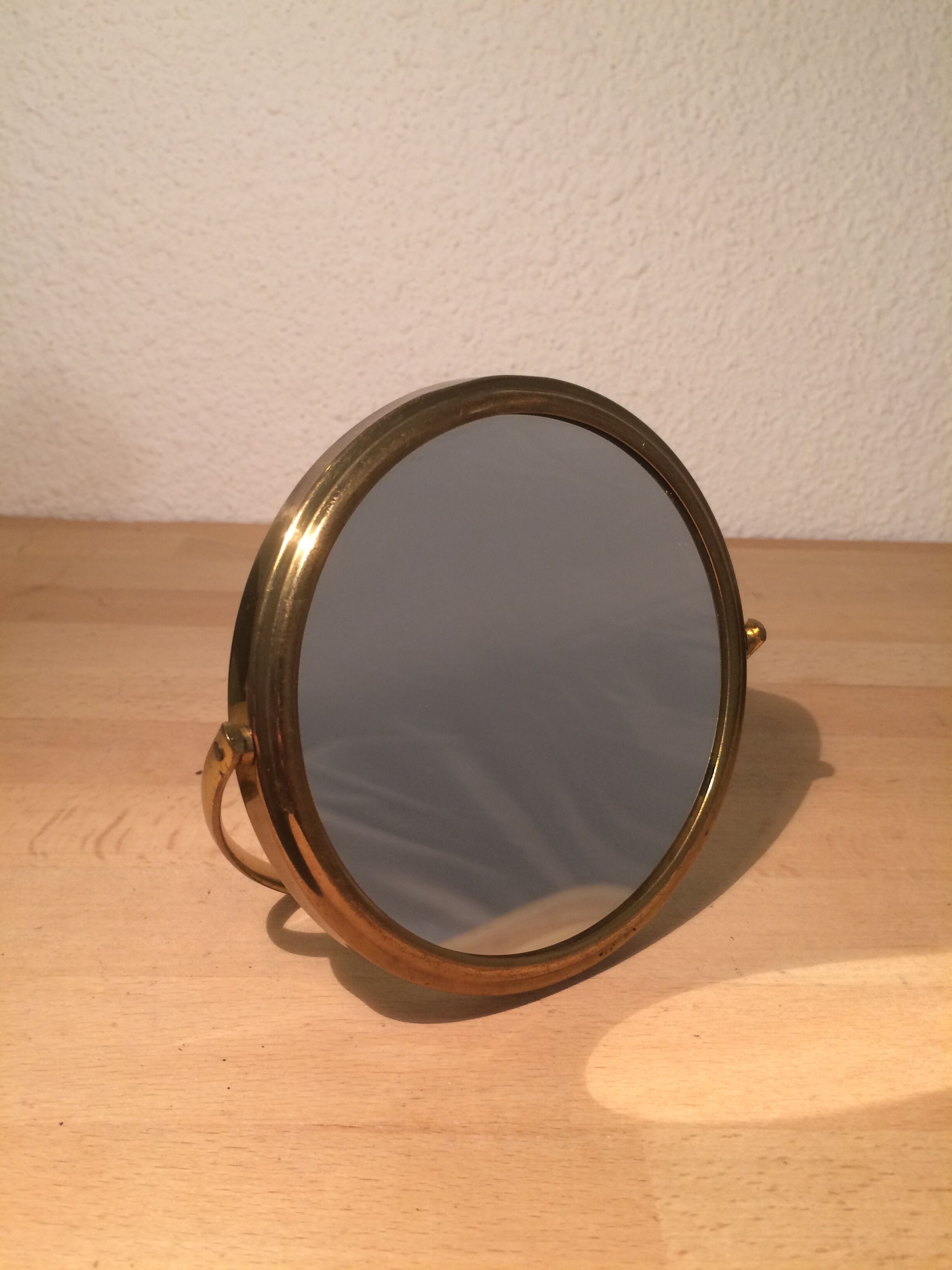 Vintage magnifiing gold round barber mirror