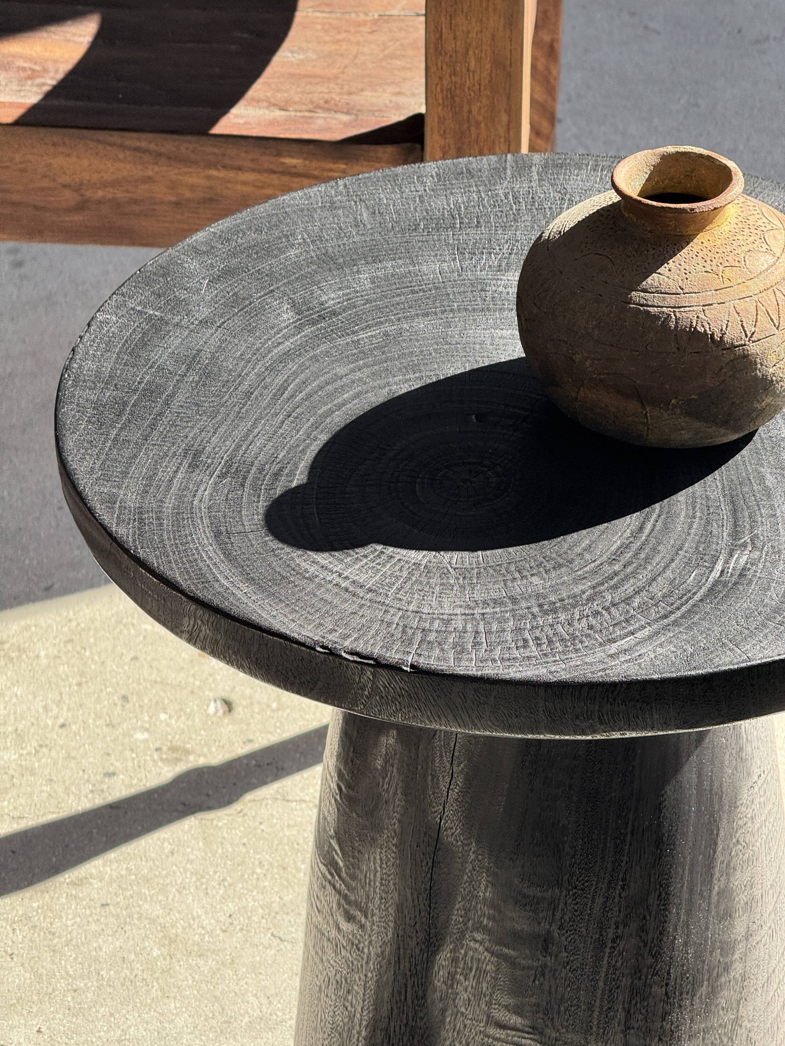 Black solid mango side table (monoxyle) with conical legs