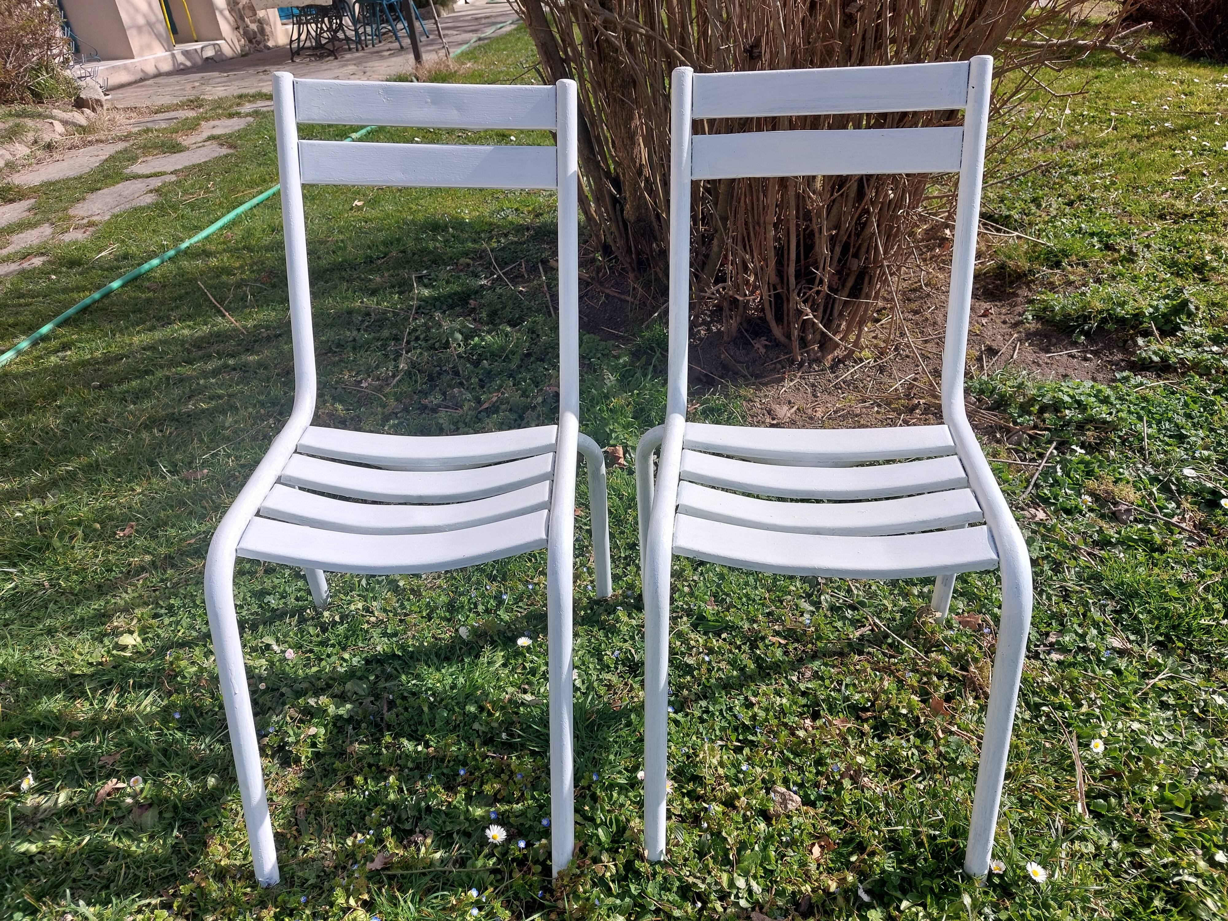 pair of white metal chairs, Tolix style