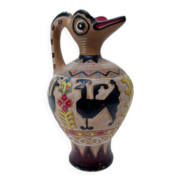 Clay pitcher with a bird head