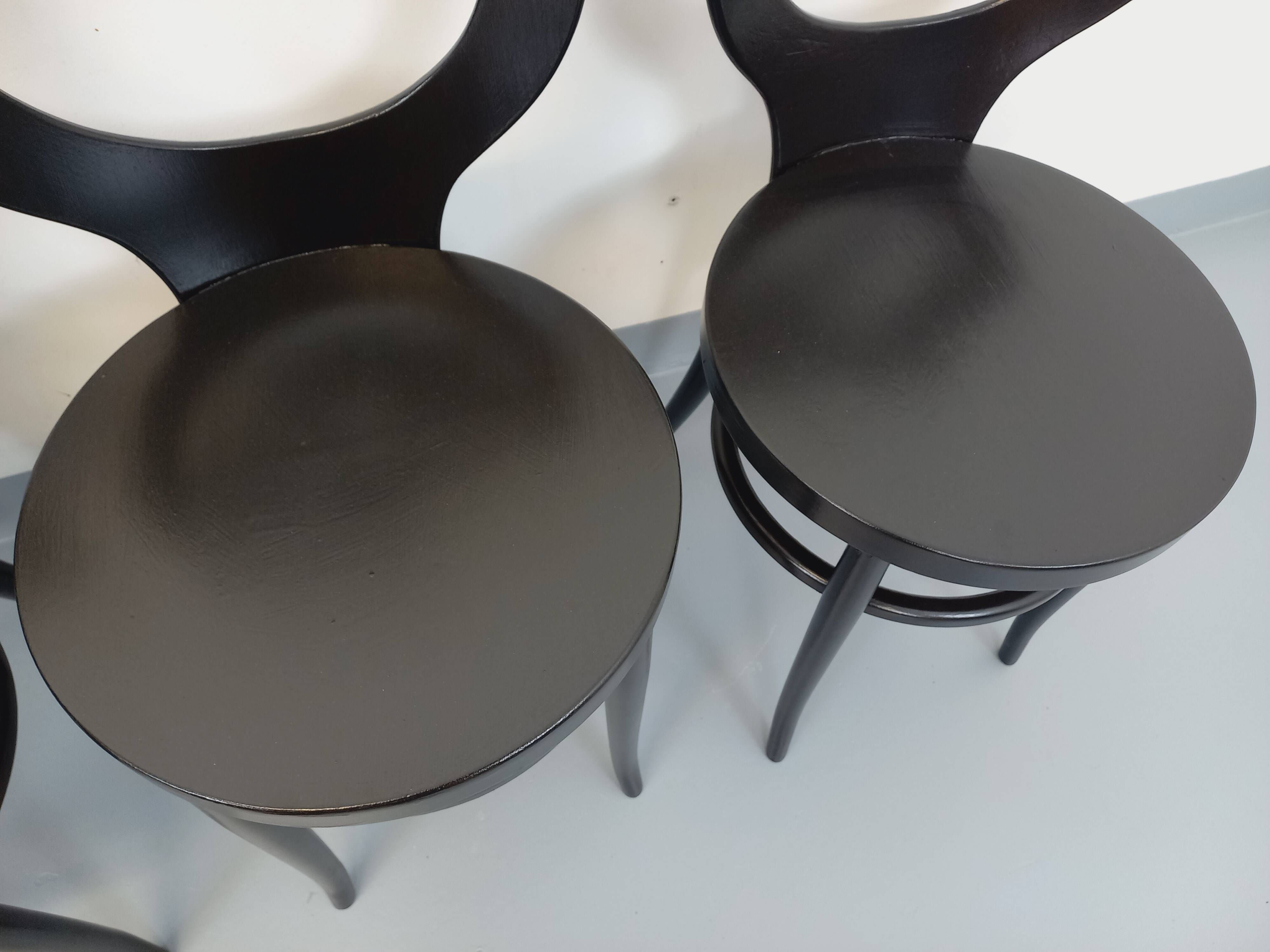 Set of 4 vintage Mouette chairs by Baumann in black wood from the 1960s.