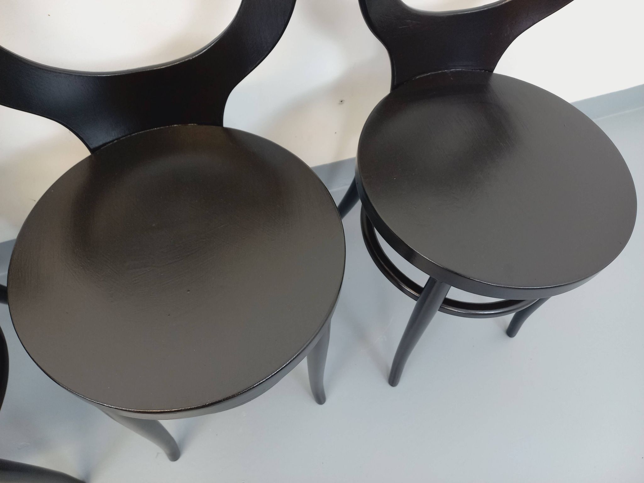 Set of 4 vintage Mouette chairs by Baumann in black wood from the 1960s.