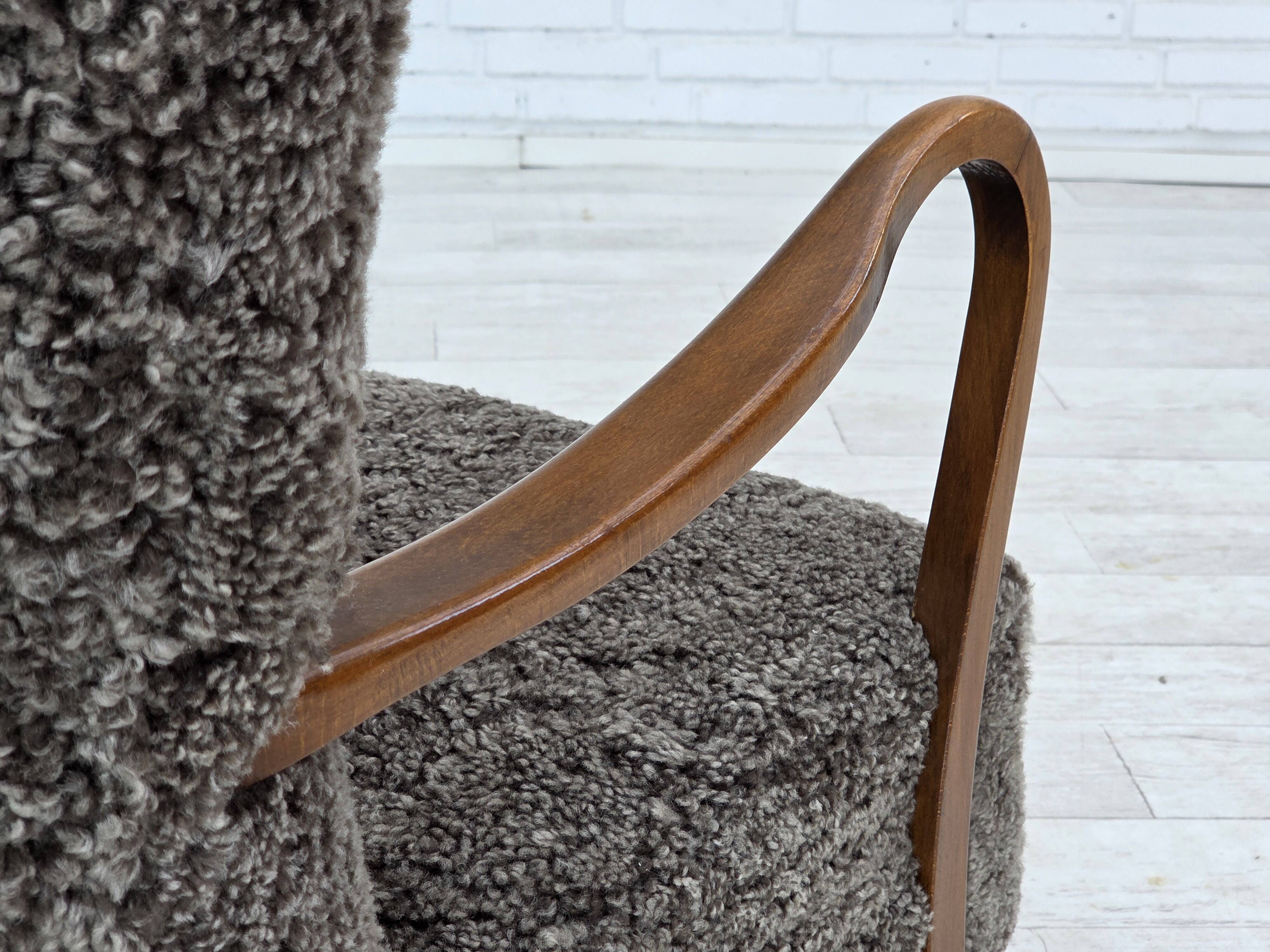 1960s, reupholstered Danish armchair, with stool, genuine sheepskin.