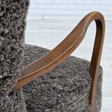 1960s, reupholstered Danish armchair, with stool, genuine sheepskin.