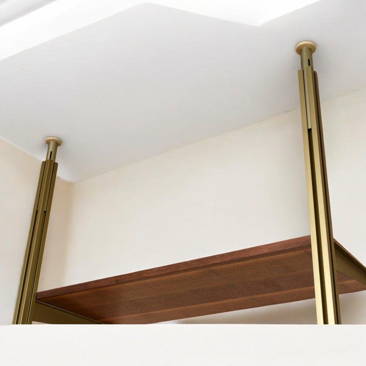 Tension pole free standing rose gold aluminum Omni wall unit by George Nelson