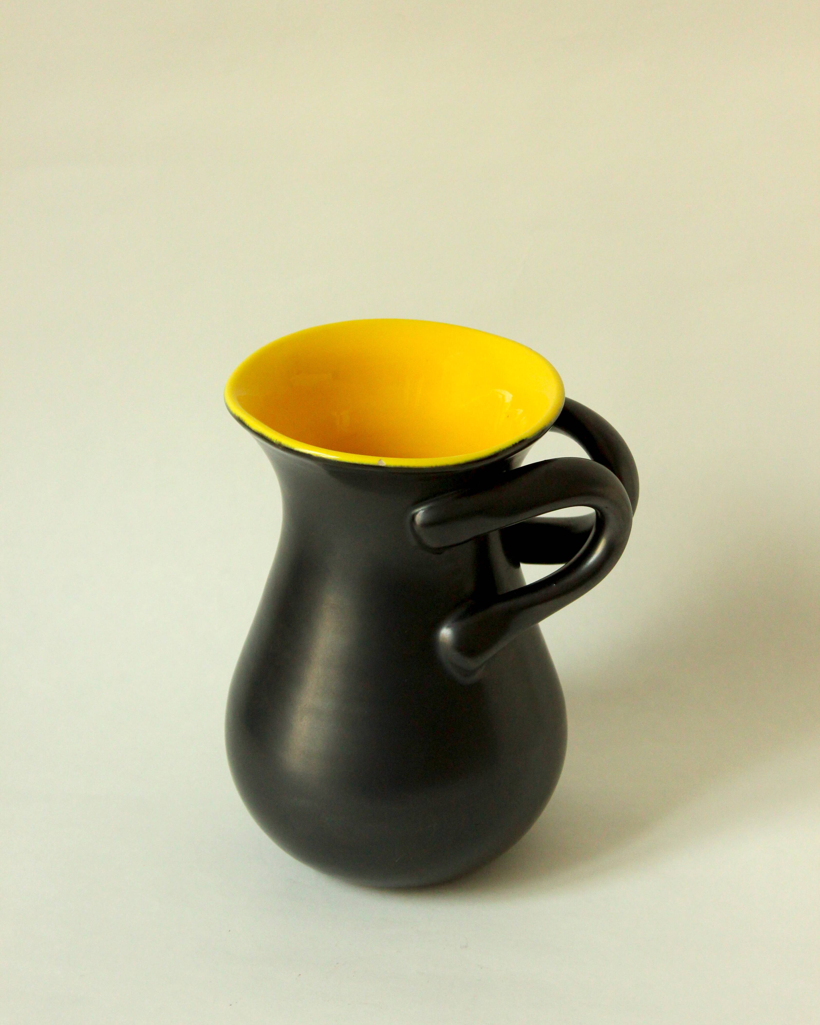 Glazed ceramic vase in black and yellow, in the style of Pol Chambost.