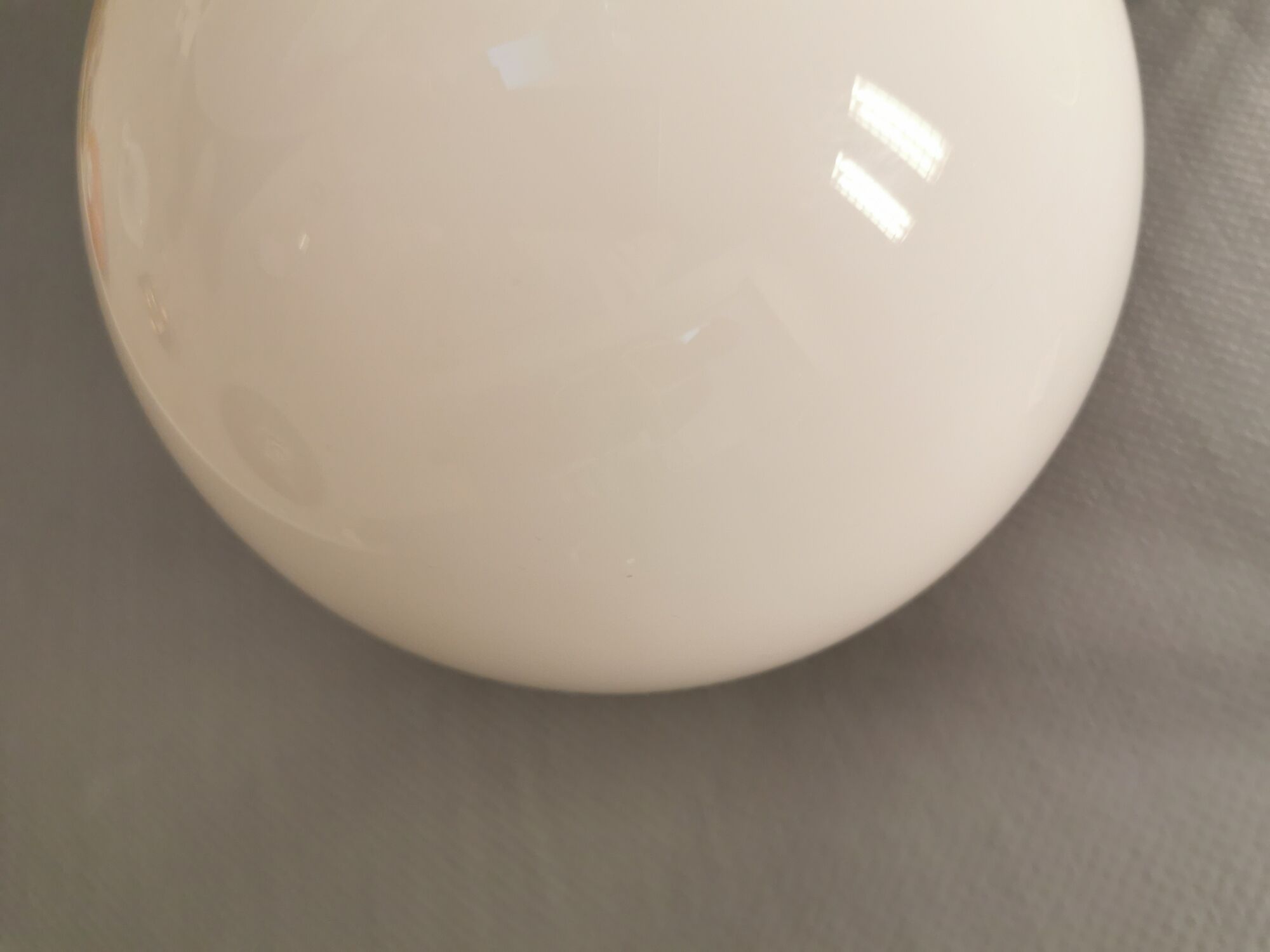 White hanging lamp with metal suspension, made with ball round opal glass shade.