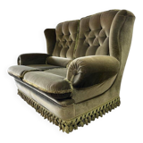 Vintage green two-seater sofa with fringes