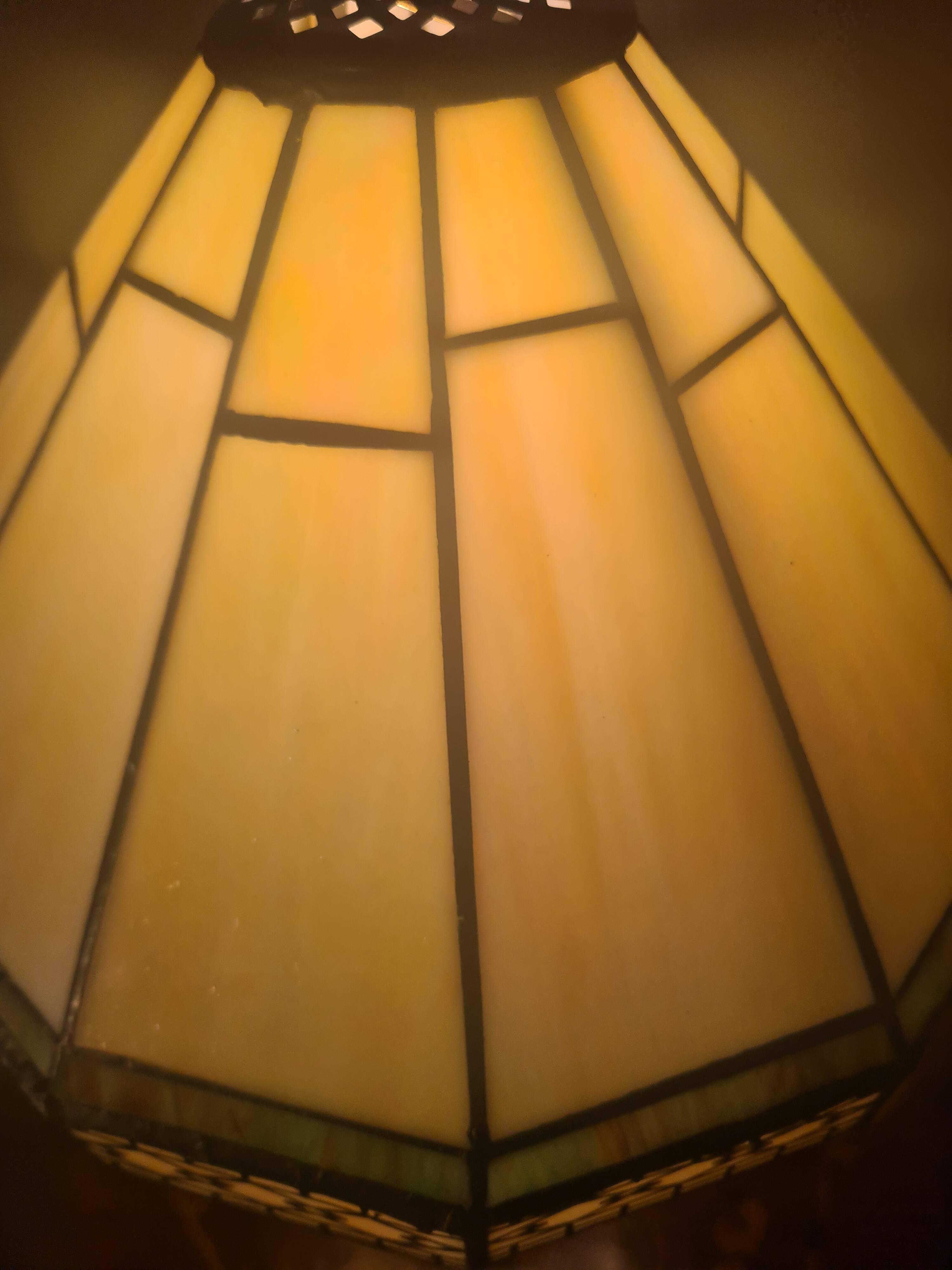 brass and bronze lamp with an antique base from 1900 and a glass paste shade