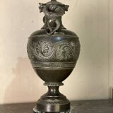 Bronze vase with snakes and a green patina, in the antique style.