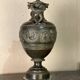 Bronze vase with snakes and a green patina, in the antique style.