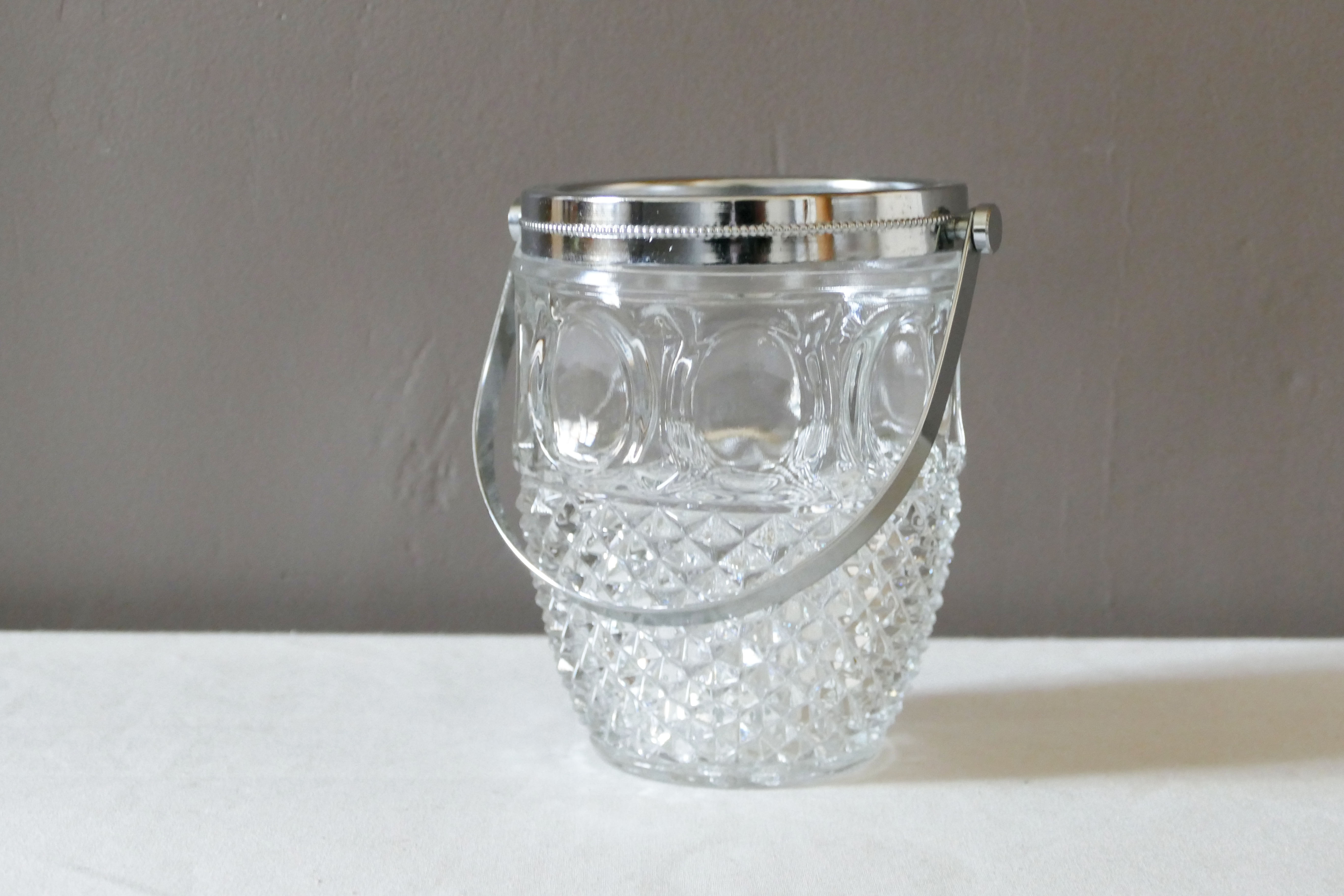 Vintage glass ice bucket stamped with a metal handle