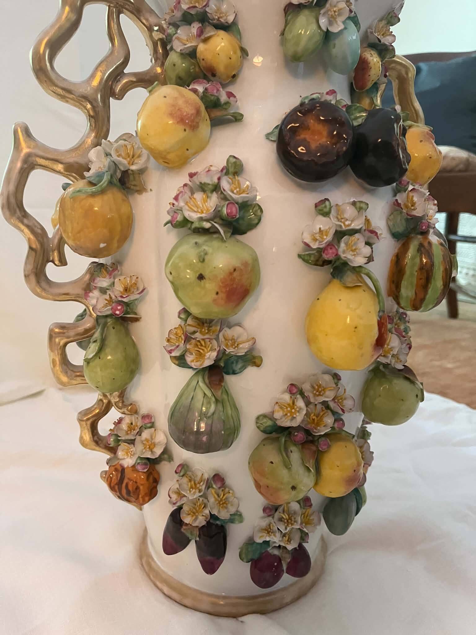 Large antique vase with relief decorations of coloured fruits.