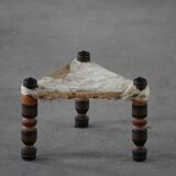 Vintage African artisanal stool, triangular shape with 3 legs, cowhide, 20th century.
