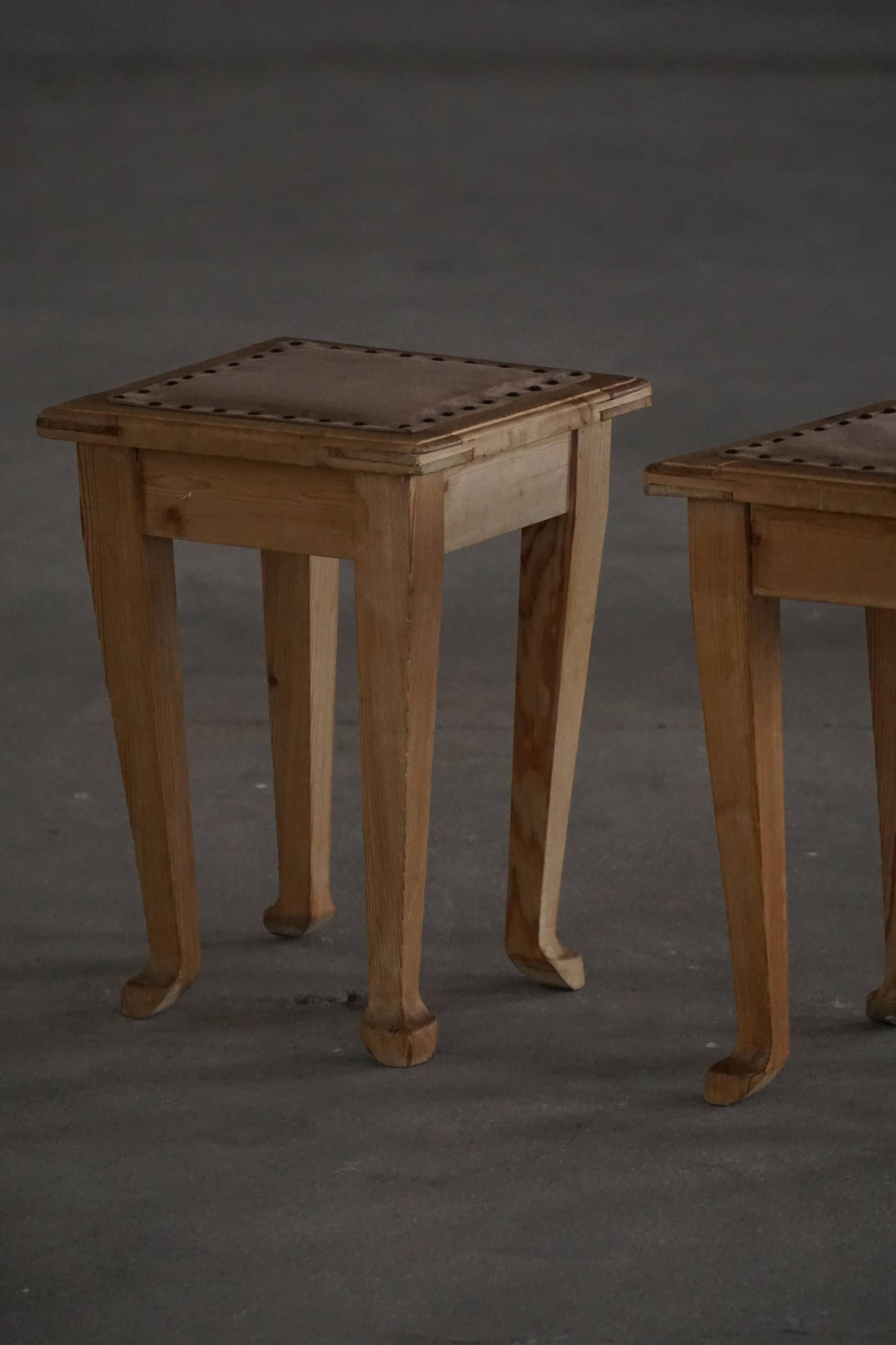 A pair of antique Danish pine stools from the late 19th century.