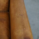 Stylish patinated vintage sheepskin armchair with a comfortable seat
