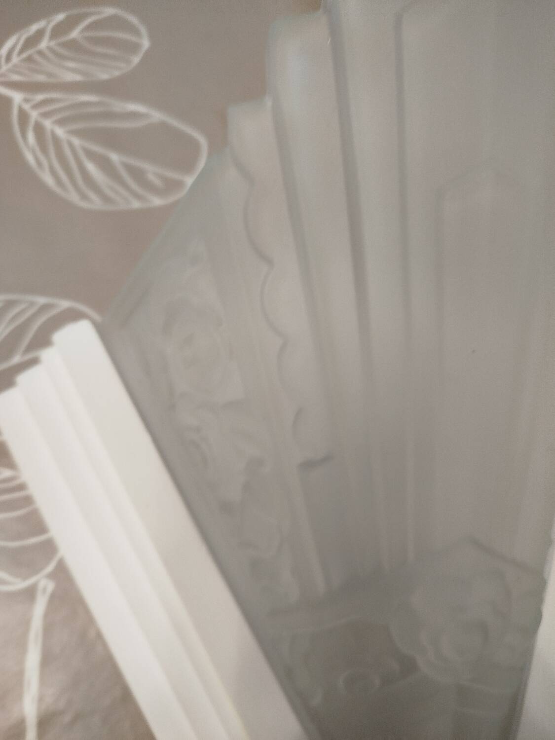 Pair of Art Deco wall sconces in plaster and pressed glass.