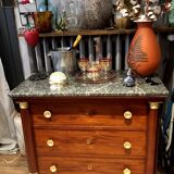 Empire chest of drawers with half columns in mahogany and gilded bronze