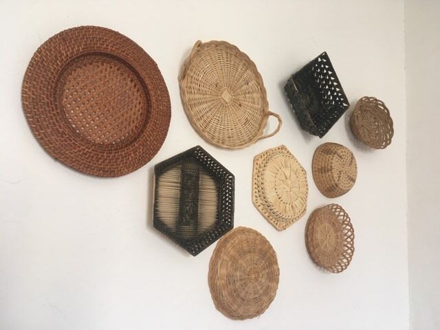 Wall composition of 9 wicker baskets and trays.