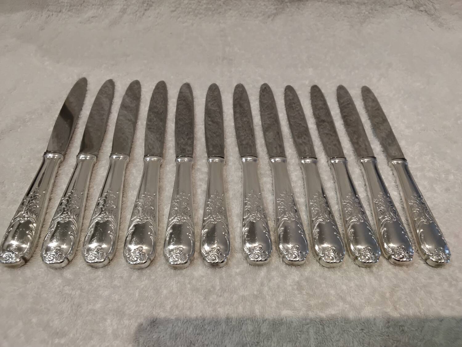 12 silver-plated dessert knives by Platil, rocaille style