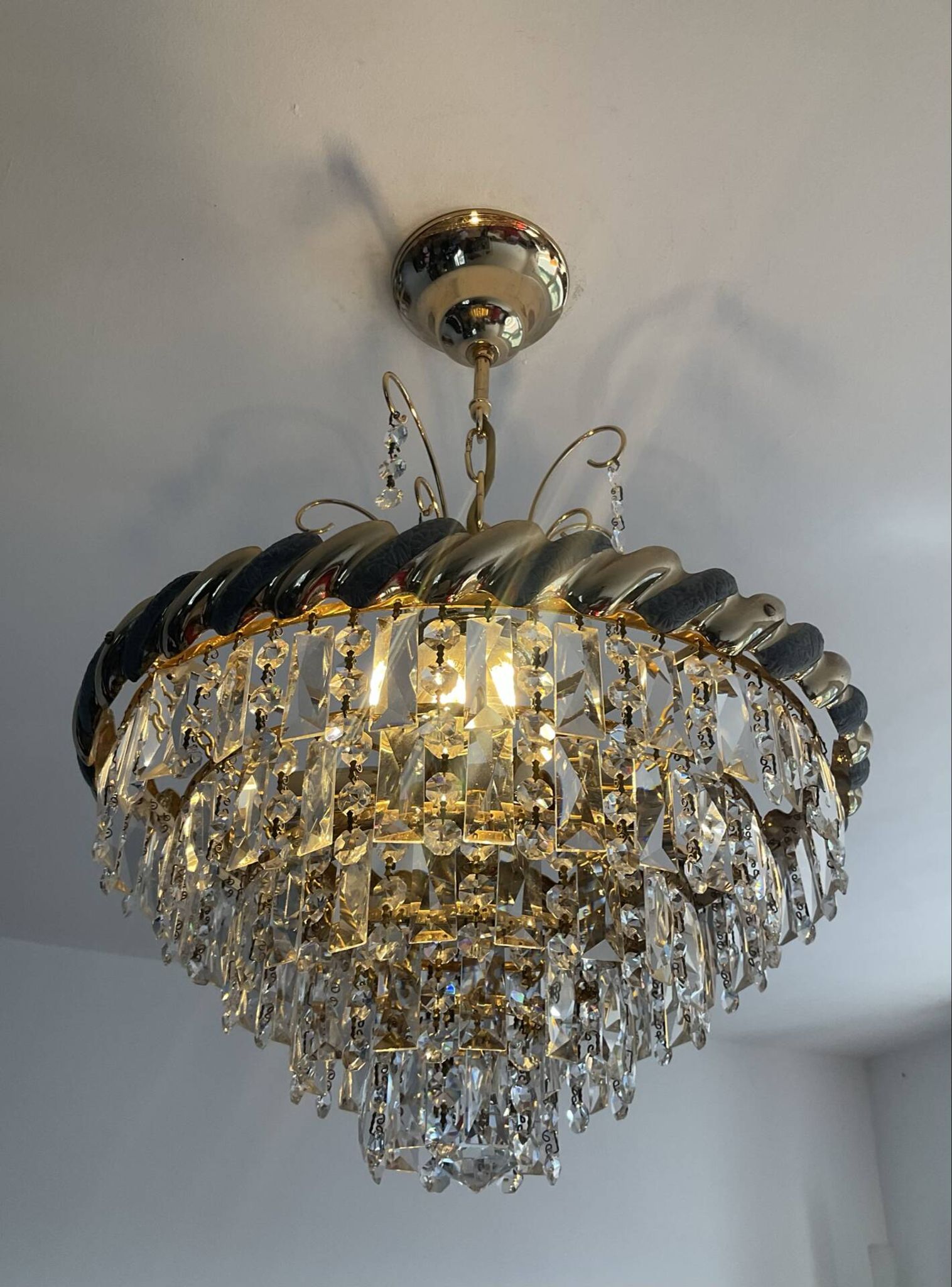 Crystal and brass chandelier with a cascade of pendants.