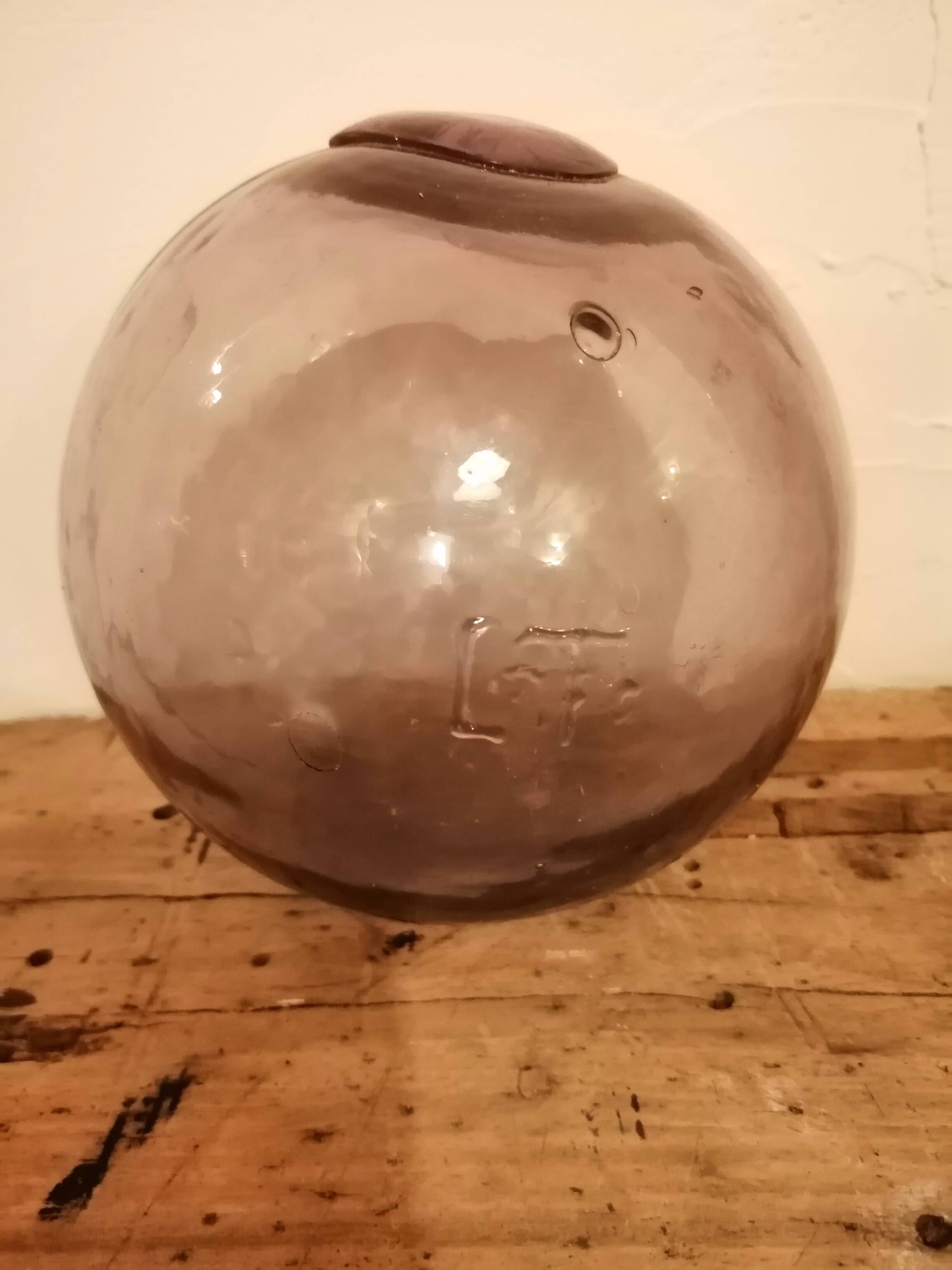 Old glass ball of fishing net marked "LT"