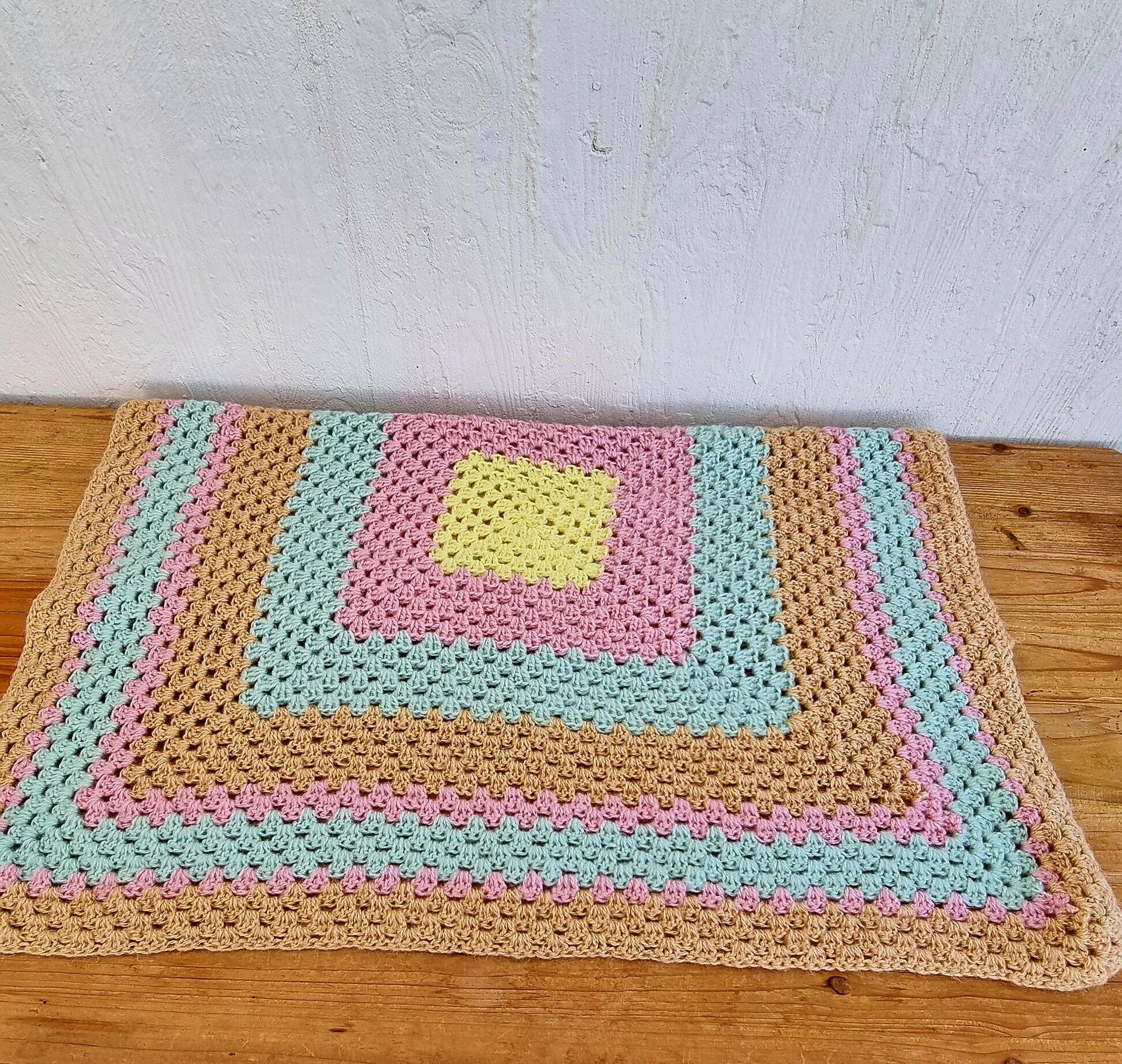Vintage pastel crochet blanket for children.