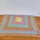 Vintage pastel crochet blanket for children.