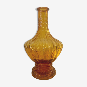 Ochre glass bottle with baroque style pattern