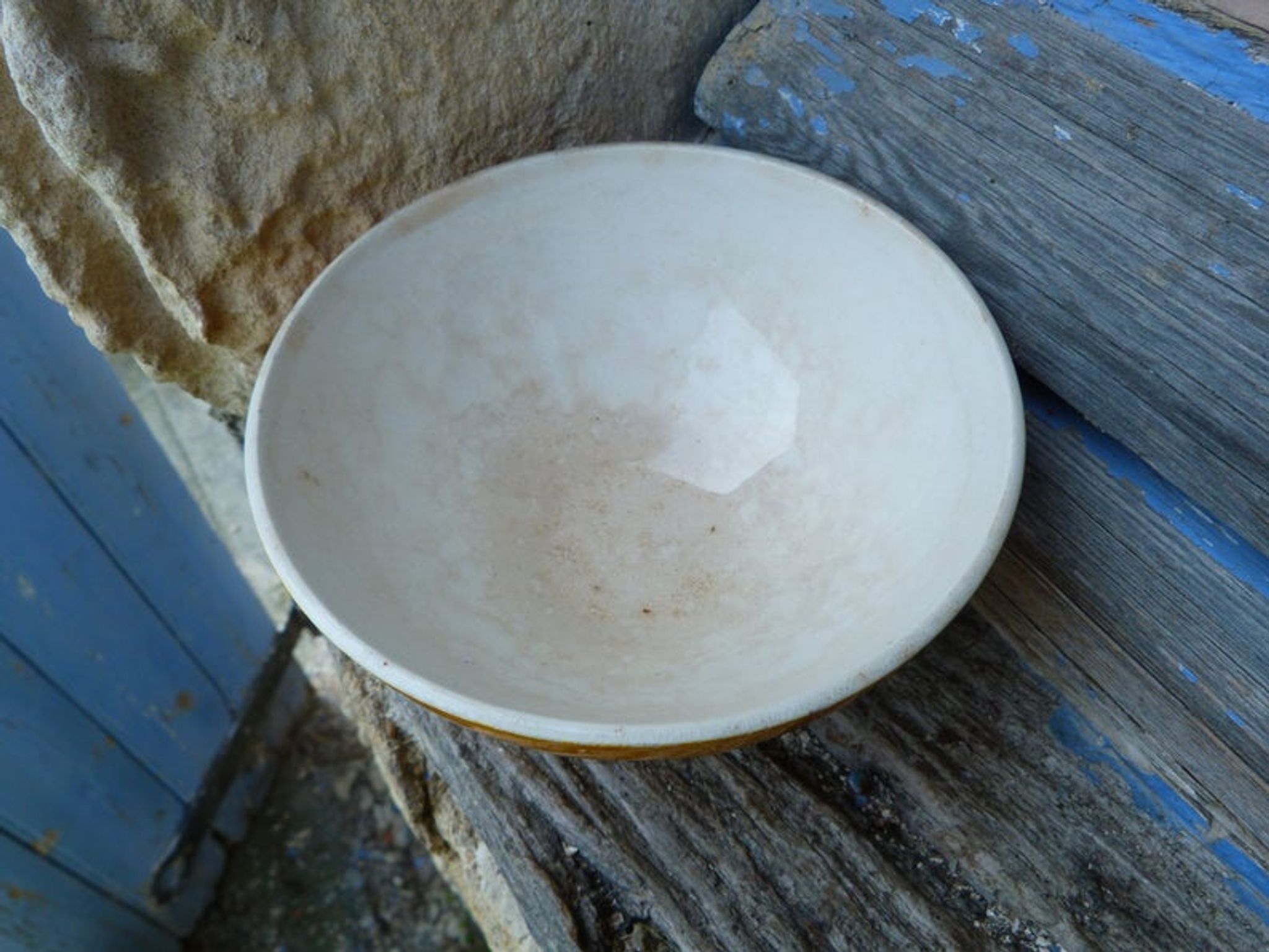 Old yellow ceramic coffee bowl with white polka dots