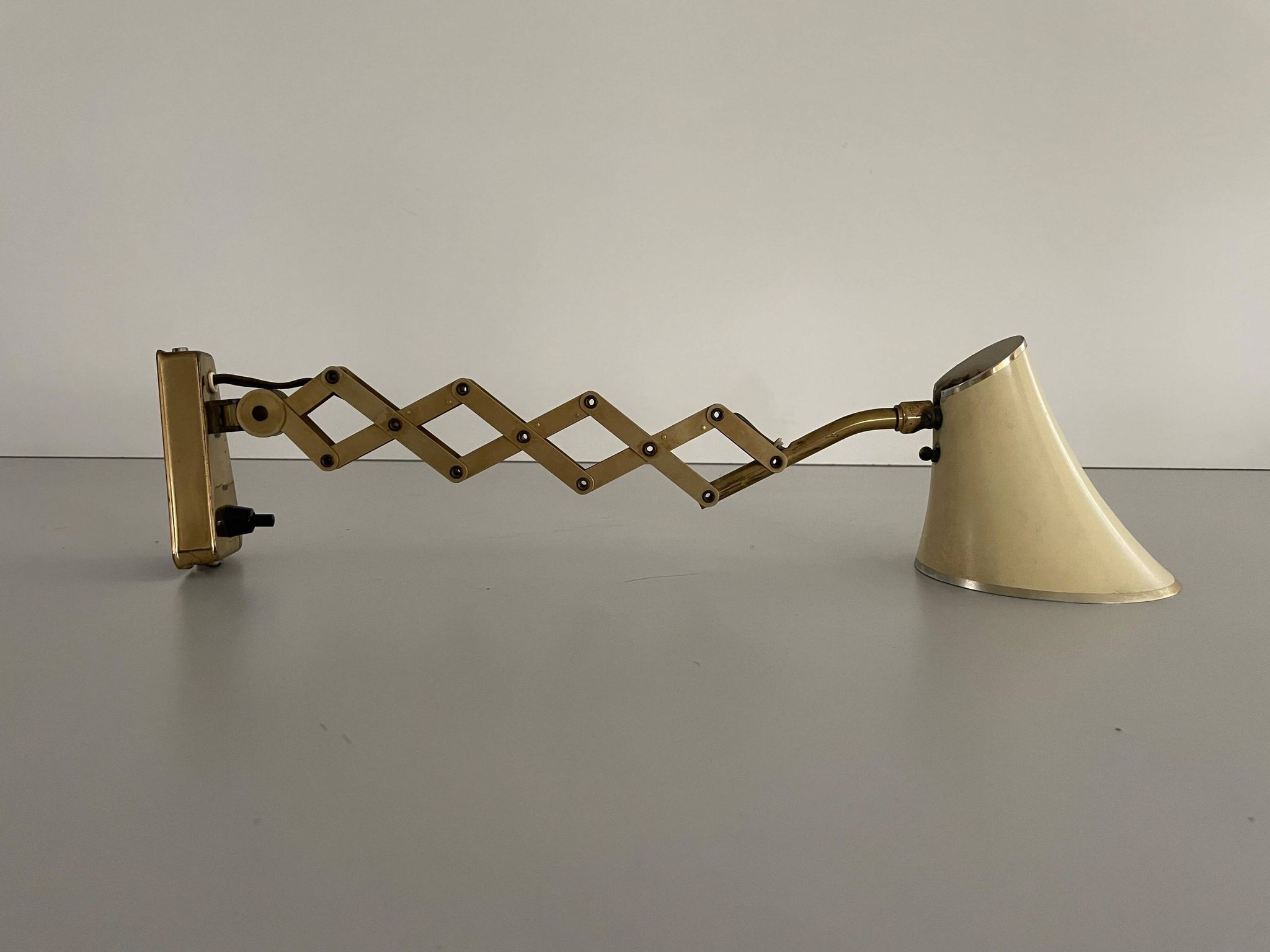 Cream metal and brass wall lamp with scissors design by Karl Lang for SIS Licht, 1950s, Germany.