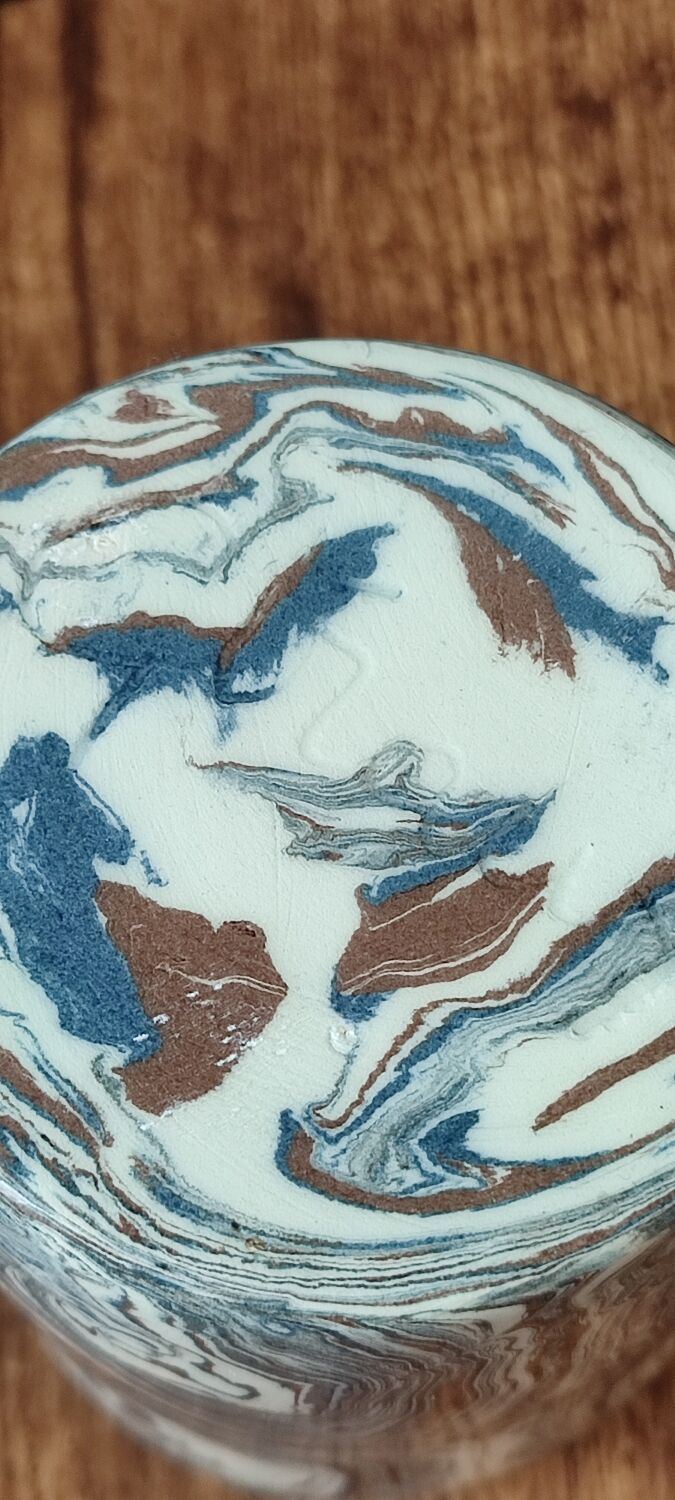 Handcrafted ceramic mug with marbled design, unique piece.