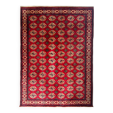 Traditional hand-knotted Turkmen Bukhara carpet. Central Asia.