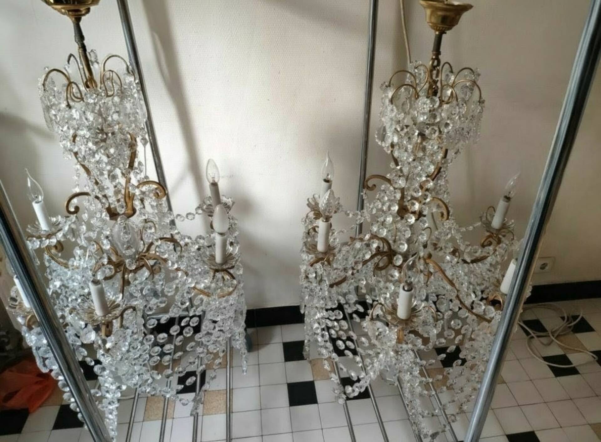 A pair of imposing, antique chandeliers with pendants.
