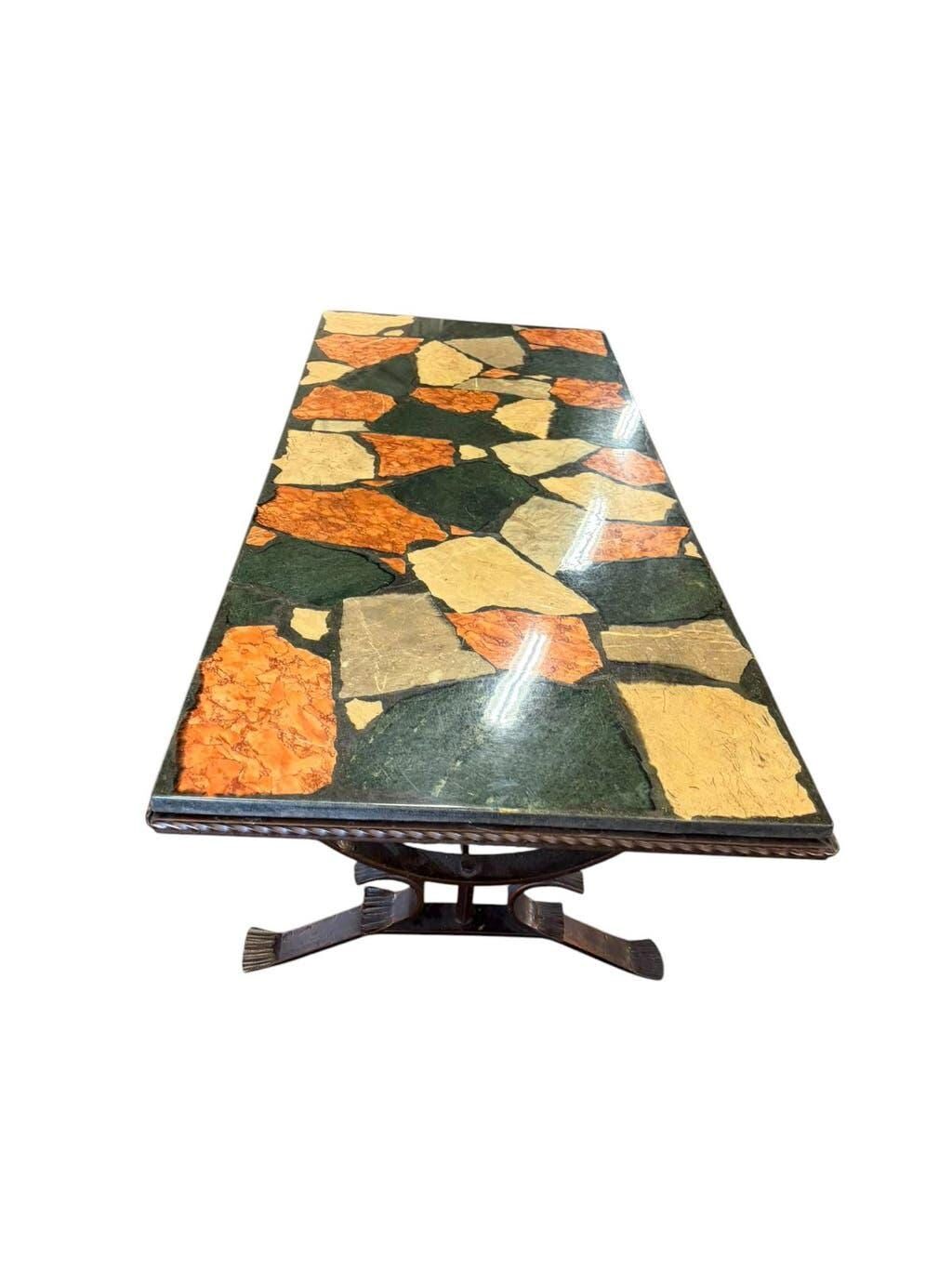 Vintage stone coffee table with a cast iron frame.