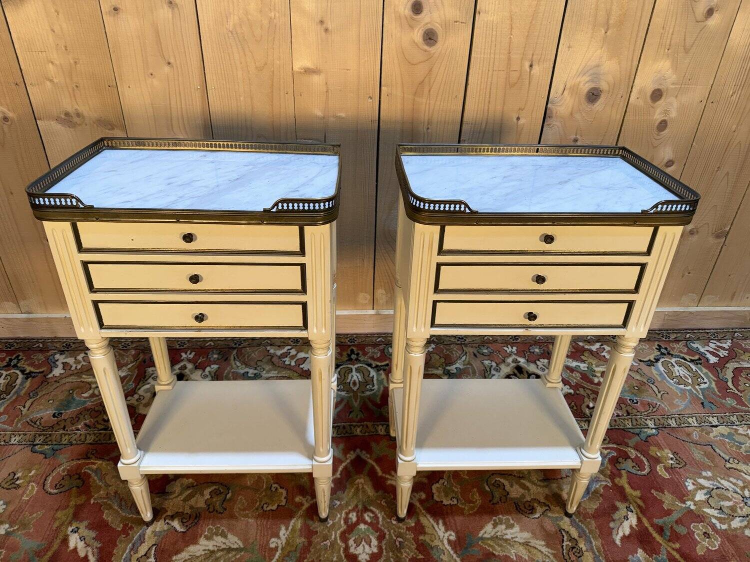 Pair of Louis XVI style bedside tables painted white.