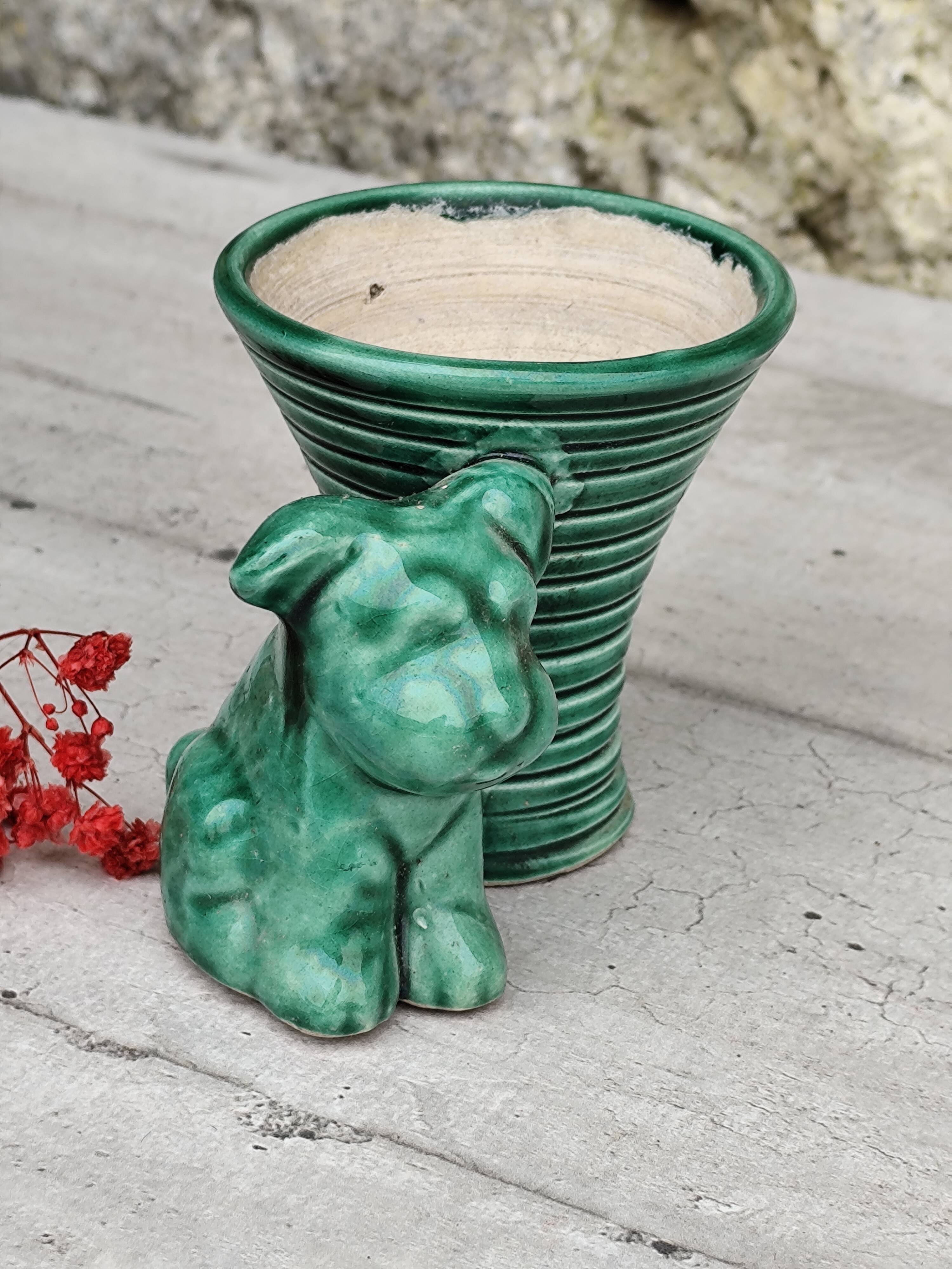 Green ceramic empty pocket dog statue