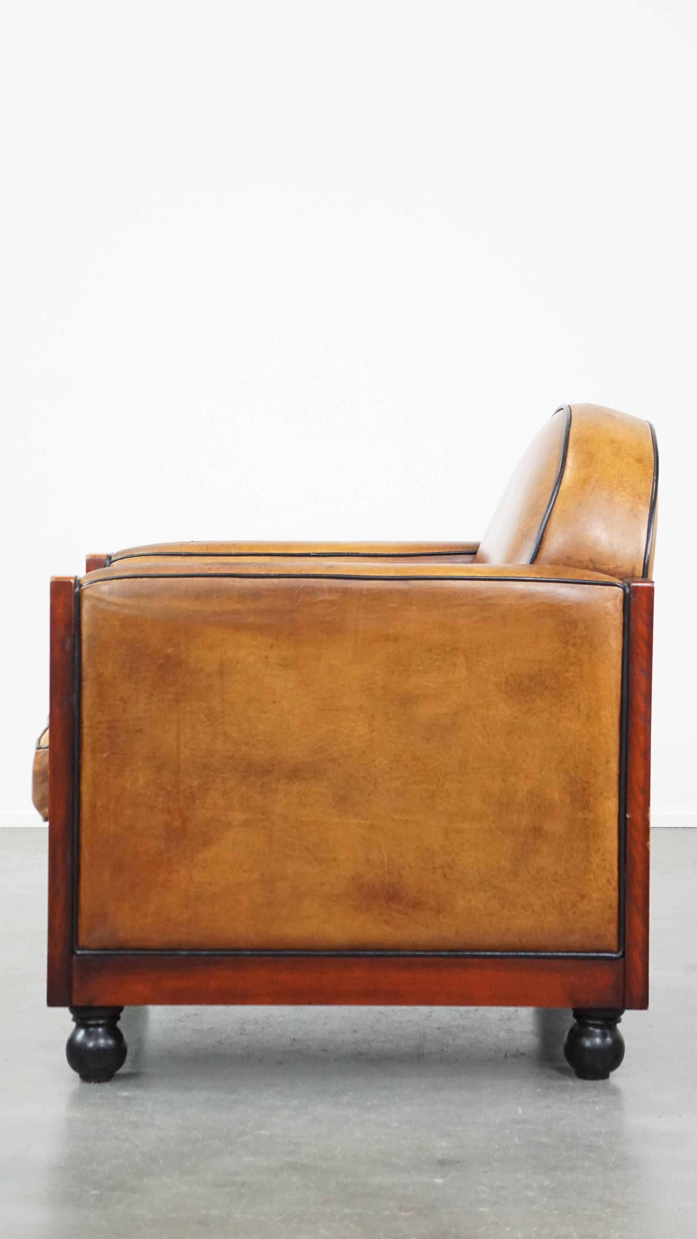 Sheep leather and wooden Art Deco design armchair with ball feet